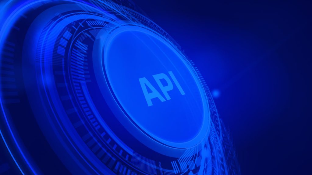 Um botão azul brilhante com a sigla "API" no centro, cercado por anéis concêntricos com padrões digitais abstratos em um fundo tecnológico azul escuro.