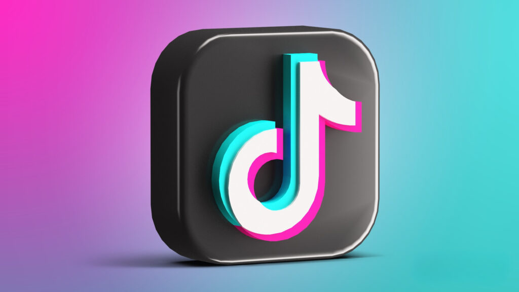Um ícone 3D do TikTok, um quadrado preto com uma nota musical branca, ciano e magenta, sobre um fundo gradiente vibrante de rosa e azul.